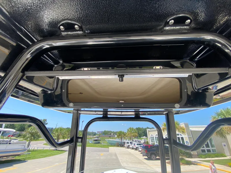 Slide: The Image of 2024 Robalo R230 Center Console T-top view with storage compartment. - 18