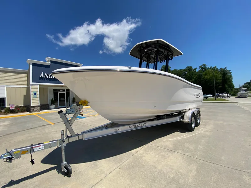 Slide: The Image of 2024 Robalo R230 Center Console boat on trailer outside dealership. - 2