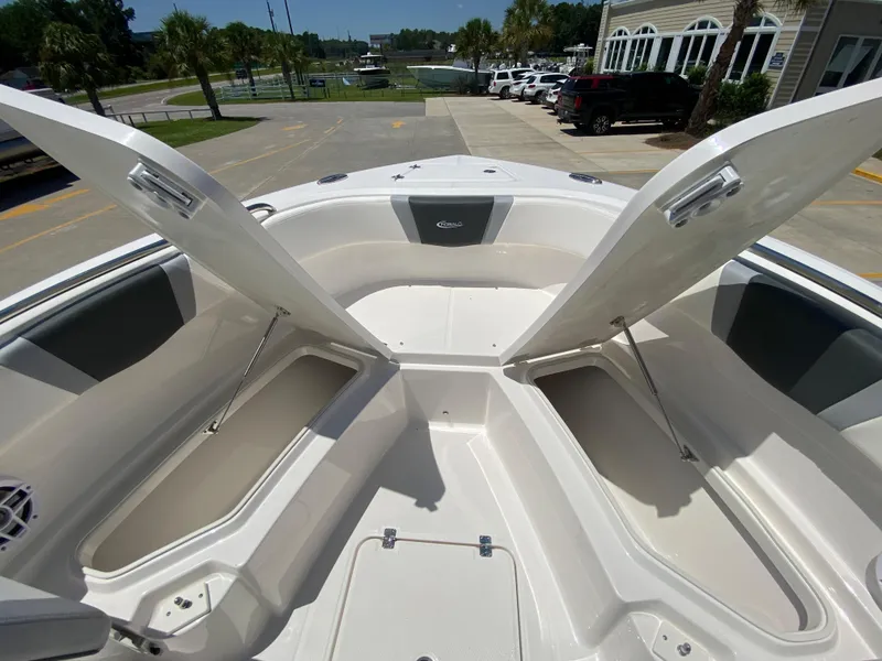 Slide: The Image of 2024 Robalo R230 Center Console boat with open storage compartments. - 23