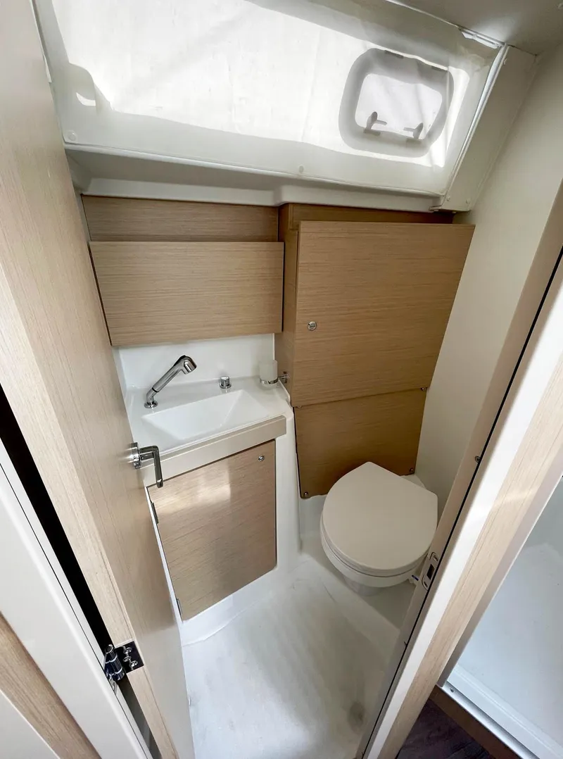 Slide: The Image of 2024 Beneteau Oceanis 38.1 yacht bathroom with modern fixtures and wood accents. - 10