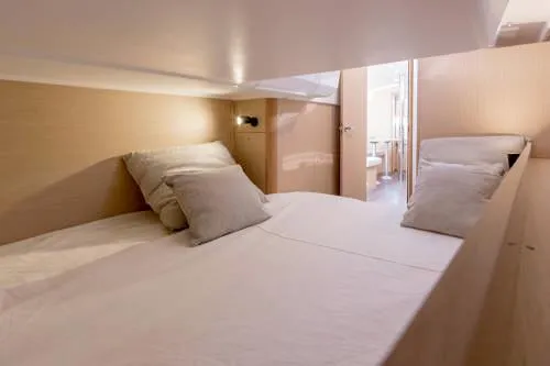 Slide: The Image of 2024 Beneteau Oceanis 38.1 cabin interior with cozy bedding and modern design. - 17