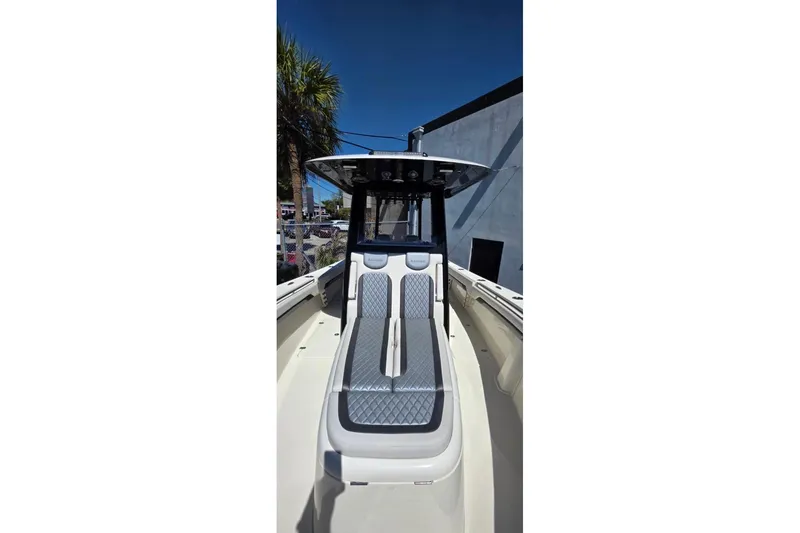 Slide: The Image of 2024 Blackwood 290 boat with sleek seating and modern design under clear blue sky. - 4