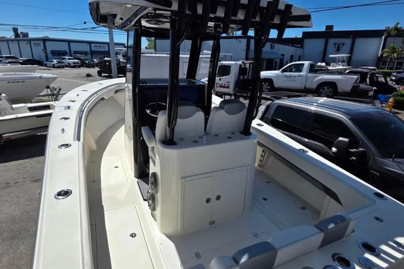 Slide: The Image of 2024 Blackwood 290 boat interior with seating and console, parked in a marina. - 5