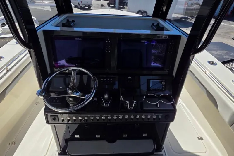 Slide: The Image of 2024 Blackwood 290 boat dashboard with steering wheel and electronic controls. - 6