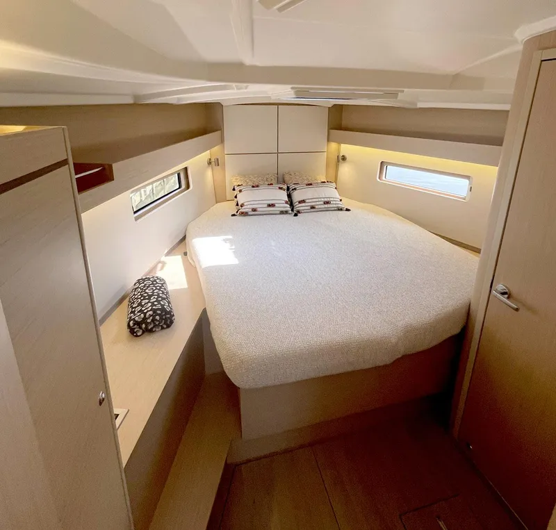 Slide: The Image of Interior cabin of 2026 Beneteau Oceanis 40.1 yacht, featuring a cozy bed and modern design. - 12