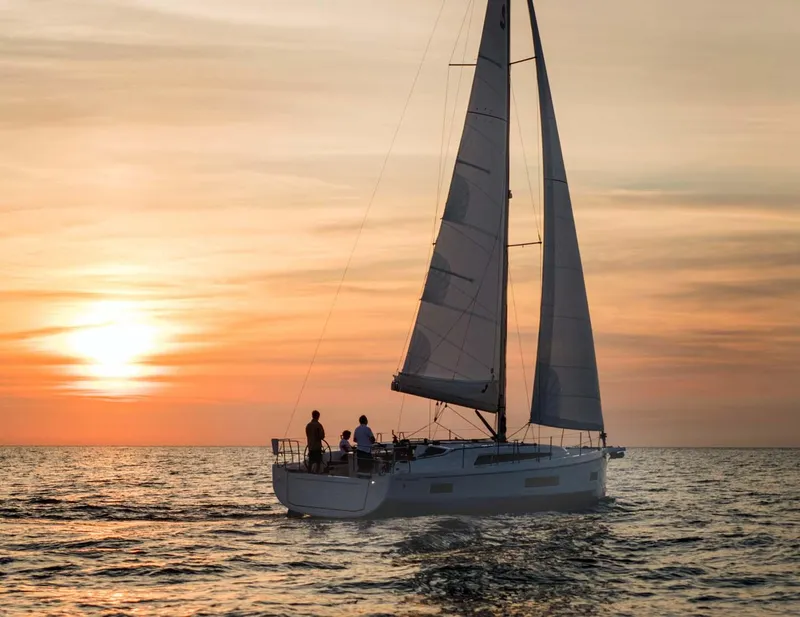 Slide: The Image of 2026 Beneteau Oceanis 40.1 sailing at sunset on calm waters. - 2