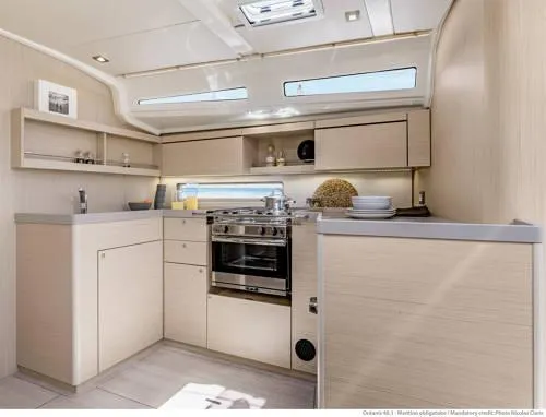 Slide: The Image of Modern kitchen interior of 2026 Beneteau Oceanis 40.1 yacht, featuring sleek cabinetry and appliances. - 24