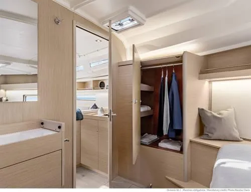 Slide: The Image of Interior of 2026 Beneteau Oceanis 40.1 yacht, featuring modern wood cabinetry and spacious wardrobe. - 31