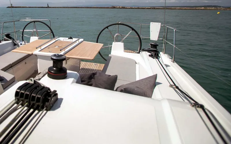 Slide: The Image of 2026 Beneteau Oceanis 40.1 yacht deck with dual steering wheels and seating area. - 6