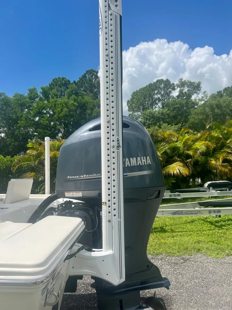 Slide: The Image of 2020 Pathfinder 2200 TRS boat with Yamaha outboard motor in a scenic outdoor setting. - 19