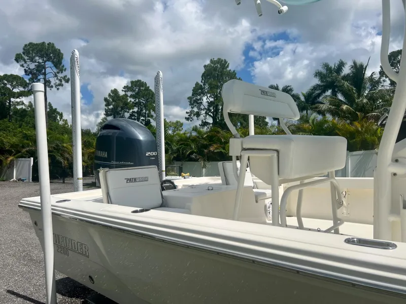Slide: The Image of 2020 Pathfinder 2200 TRS boat with Yamaha 200 engine, parked outdoors. - 7