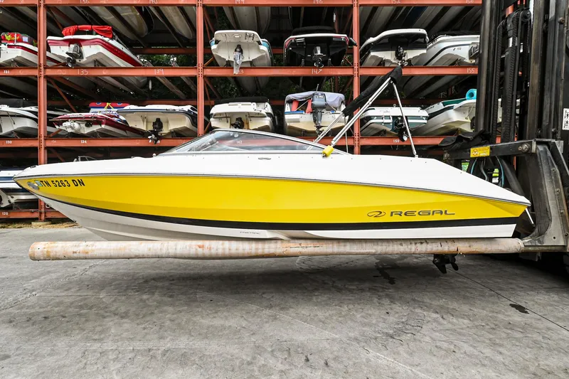 Slide: The Image of 2006 Regal 2000 Bowrider in yellow, stored on a rack in a marina. - 0