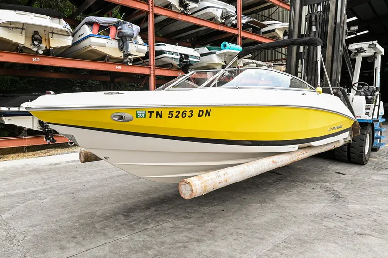 Slide: The Image of 2006 Regal 2000 Bowrider boat in storage, yellow and white hull, TN 5263 DN. - 1