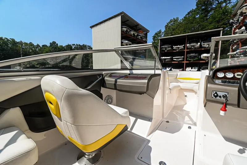 Slide: The Image of 2006 Regal 2000 Bowrider interior with helm, seating, and storage facility in background. - 11