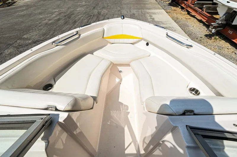 Slide: The Image of 2006 Regal 2000 Bowrider boat interior with white seating and open bow area. - 20
