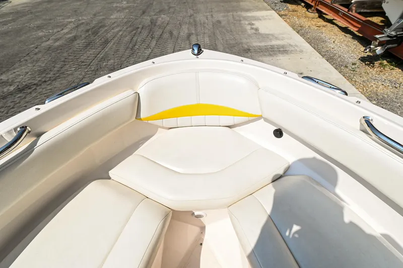 Slide: The Image of 2006 Regal 2000 Bowrider boat with white and yellow seating. - 22
