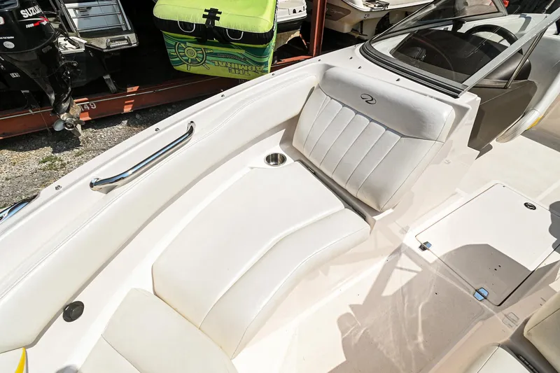 Slide: The Image of 2006 Regal 2000 Bowrider boat interior with white seating and cup holder. - 23