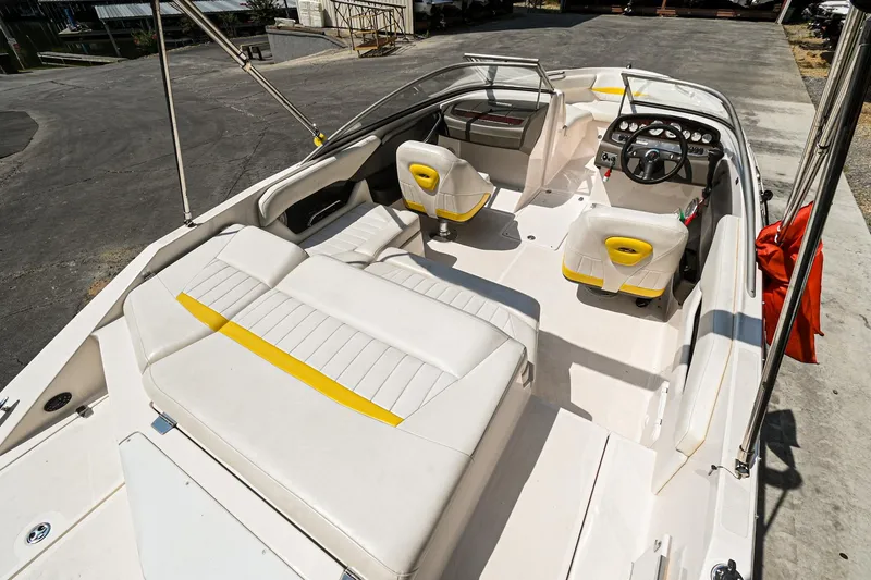 Slide: The Image of 2006 Regal 2000 Bowrider boat interior with white and yellow seating. - 4