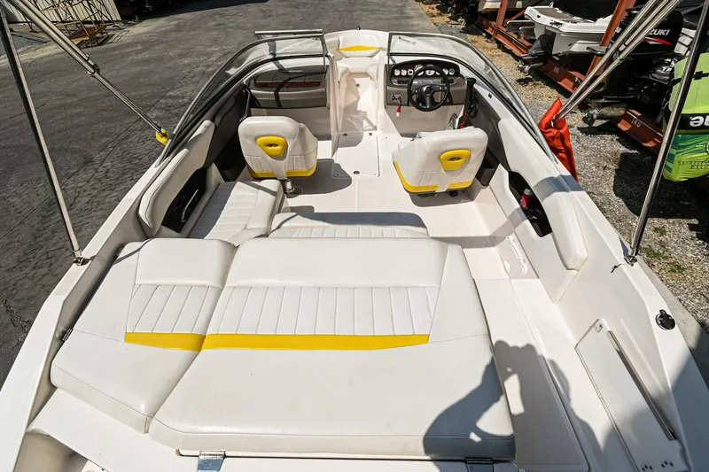 Slide: The Image of 2006 Regal 2000 Bowrider boat interior with white and yellow seating. - 6