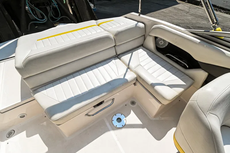 Slide: The Image of 2006 Regal 2000 Bowrider boat interior seating area with white and yellow upholstery. - 7