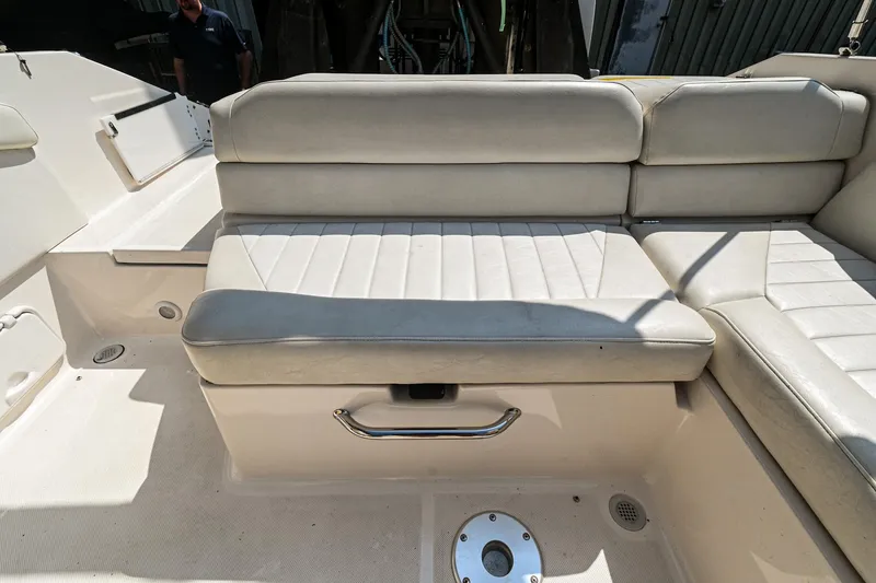 Slide: The Image of 2006 Regal 2000 Bowrider boat interior seating area with white upholstery. - 8