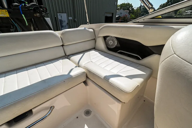 Slide: The Image of Interior seating of a 2006 Regal 2000 Bowrider boat with white upholstery. - 9