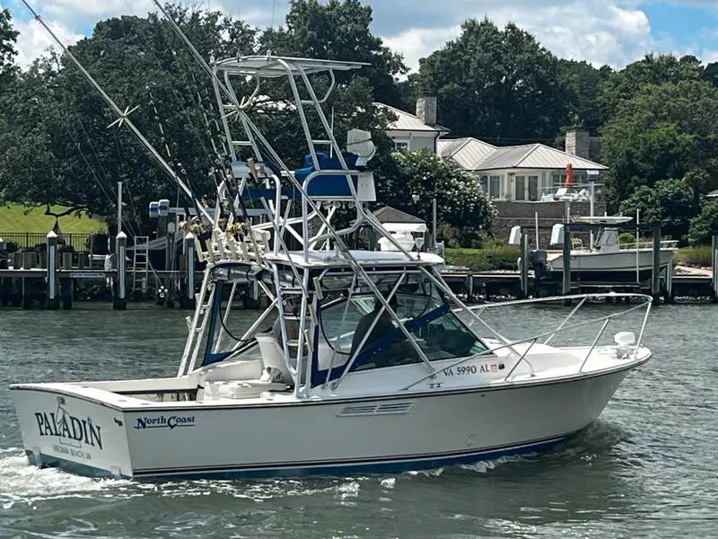 The Image of 1988 NorthCoast 24 Express Sportfish boat cruising near a dockside house. - 0