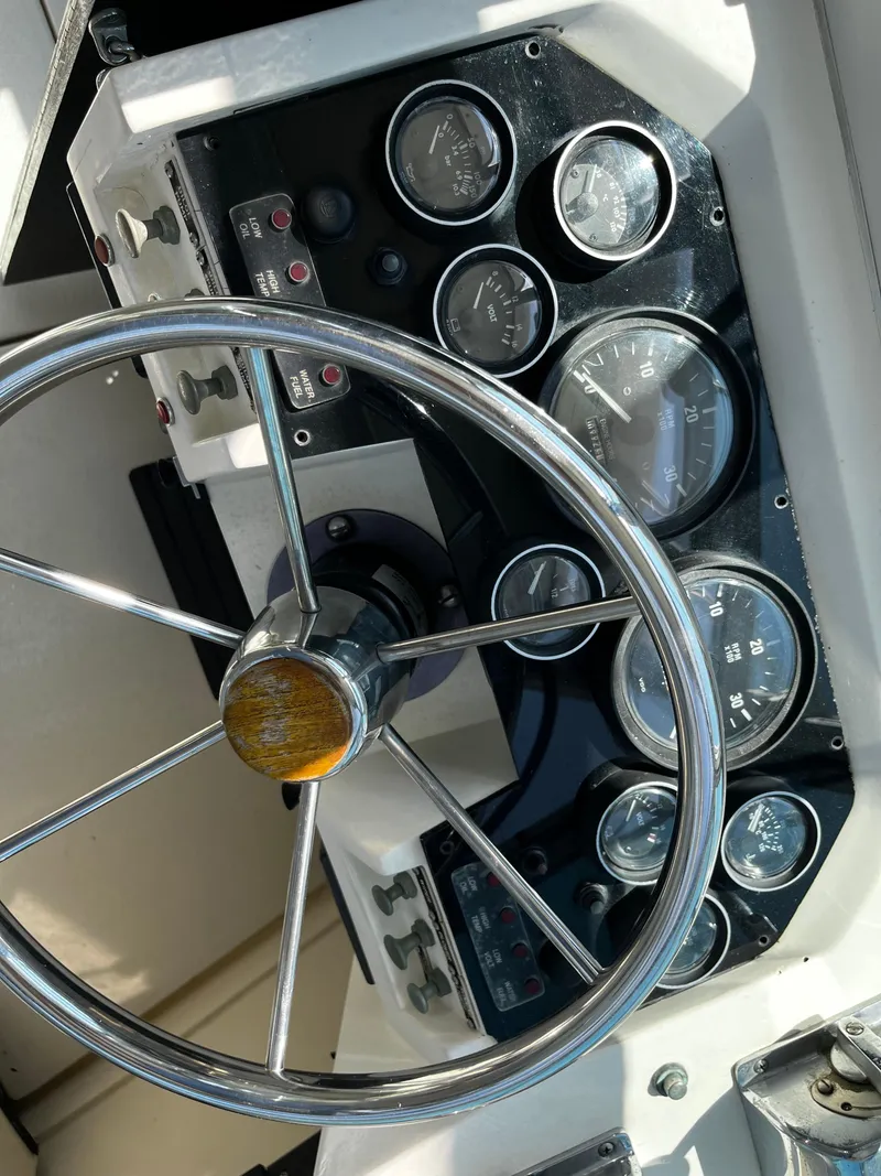 Slide: The Image of Steering wheel and dashboard of 1988 NorthCoast 24 Express Sportfish boat. - 16
