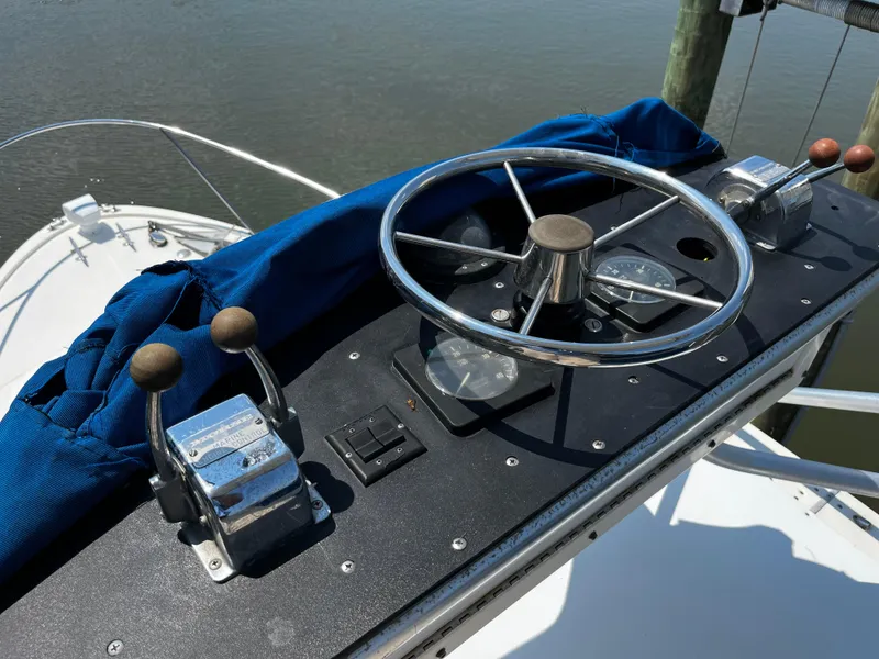 Slide: The Image of 1988 NorthCoast 24 Express Sportfish helm with steering wheel and throttle controls. - 20
