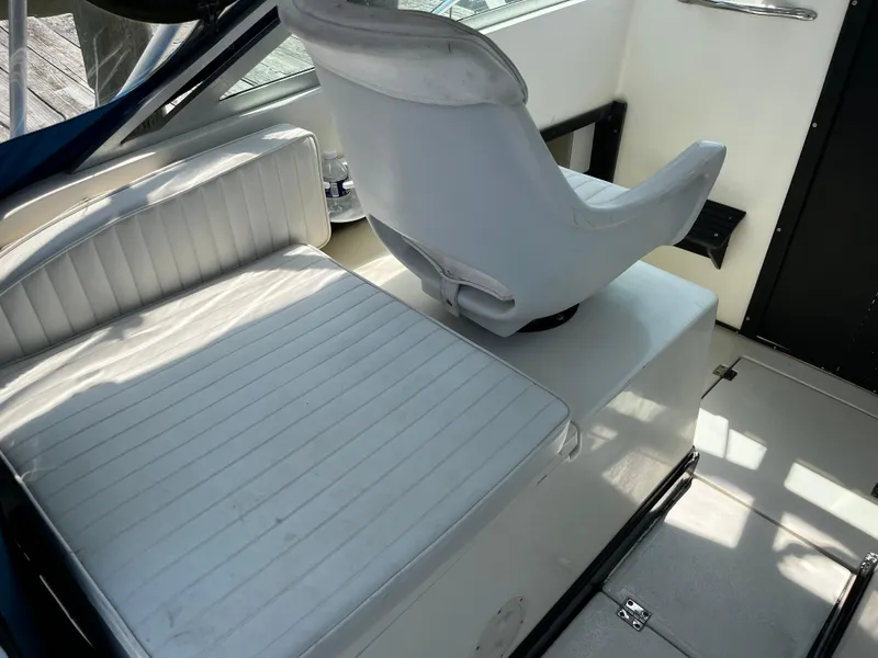 Slide: The Image of Interior seating of 1988 NorthCoast 24 Express Sportfish boat, featuring white cushioned seats. - 23
