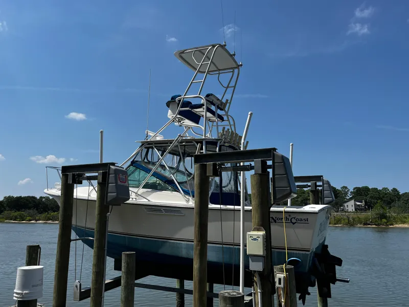 Slide: The Image of 1988 NorthCoast 24 Express Sportfish boat docked by the water under a clear blue sky. - 27