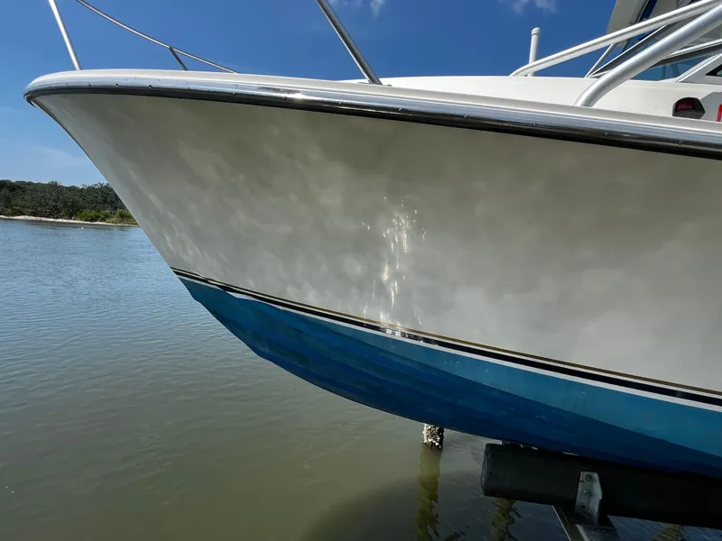 Slide: The Image of 1988 NorthCoast 24 Express Sportfish boat on water, showcasing sleek hull design. - 31