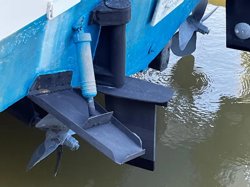 Slide: The Image of 1988 NorthCoast 24 Express Sportfish boat propeller and rudder in water. - 33