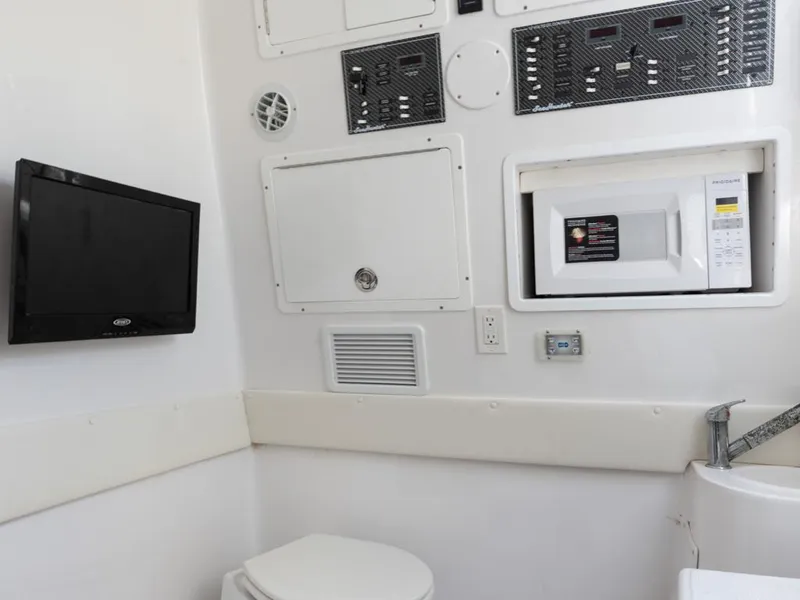 Slide: The Image of 2017 SeaHunter 45 Tournament boat interior with TV, microwave, and control panels. - 28