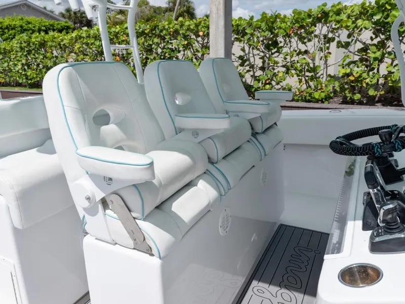 Slide: The Image of 2017 SeaHunter 45 Tournament boat with white cushioned seats and control panel. - 33
