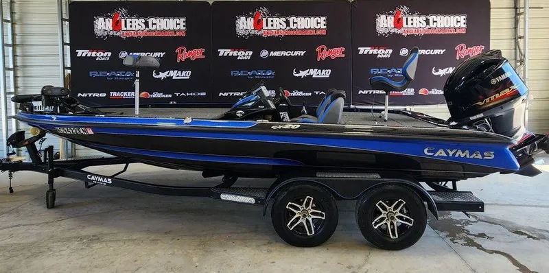 The Image of 2020 Caymas CX 20 bass boat on a trailer, displayed indoors. - 1