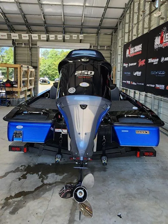 Slide: The Image of 2020 Caymas CX 20 boat in a garage, rear view. - 2