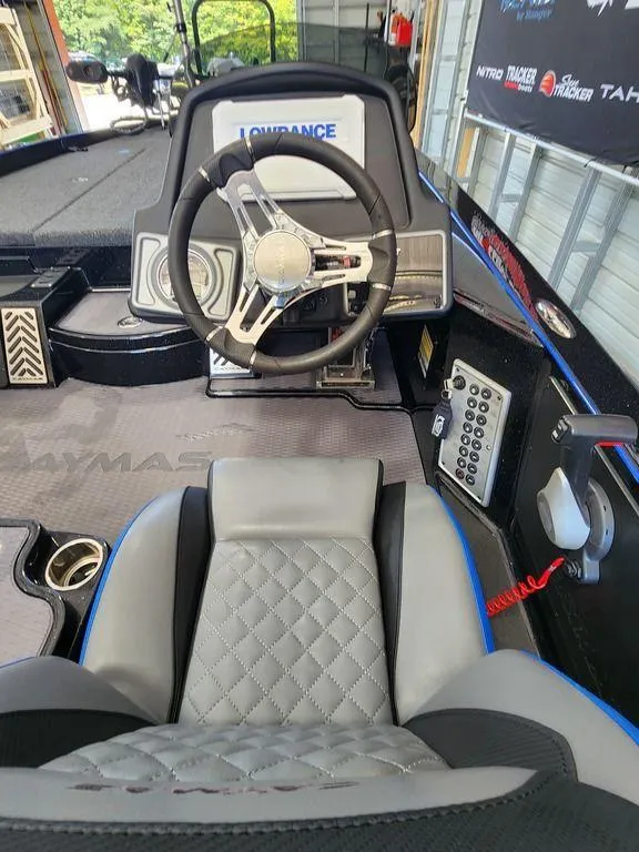 Slide: The Image of 2020 Caymas CX 20 boat cockpit with steering wheel and control panel. - 9
