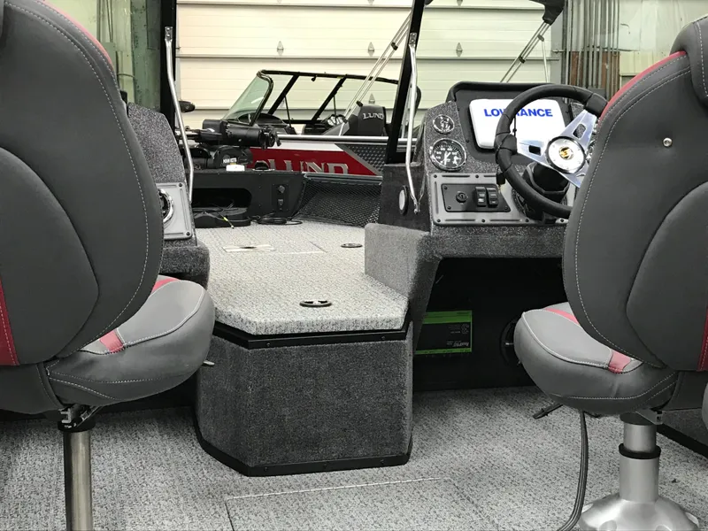 Slide: The Image of 2024 Ranger VS1782SC Angler boat interior with seating and dashboard in a garage. - 10
