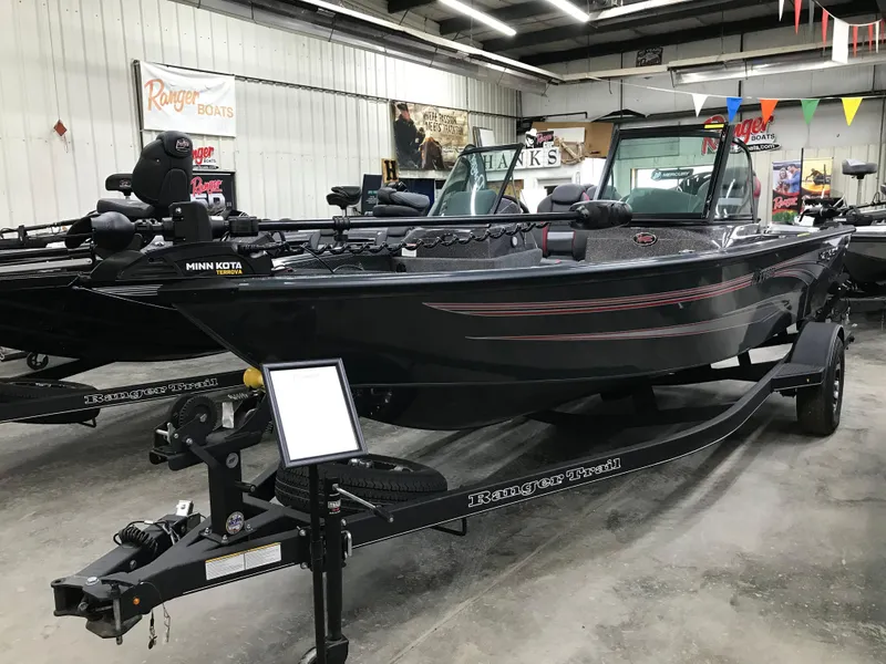 Slide: The Image of 2024 Ranger VS1782SC Angler boat displayed in showroom with trailer. - 2