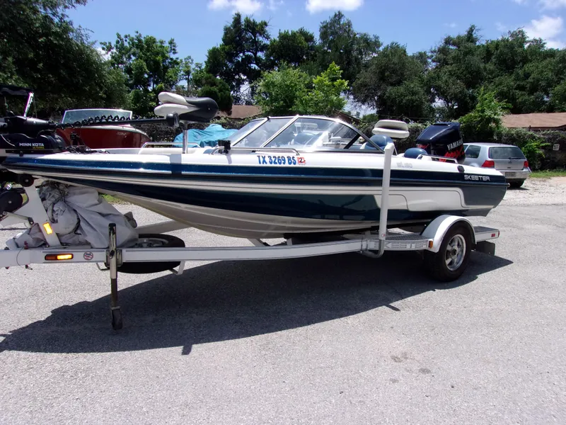The Image of 2007 Skeeter SL 180 boat on a trailer in a parking lot. - 0