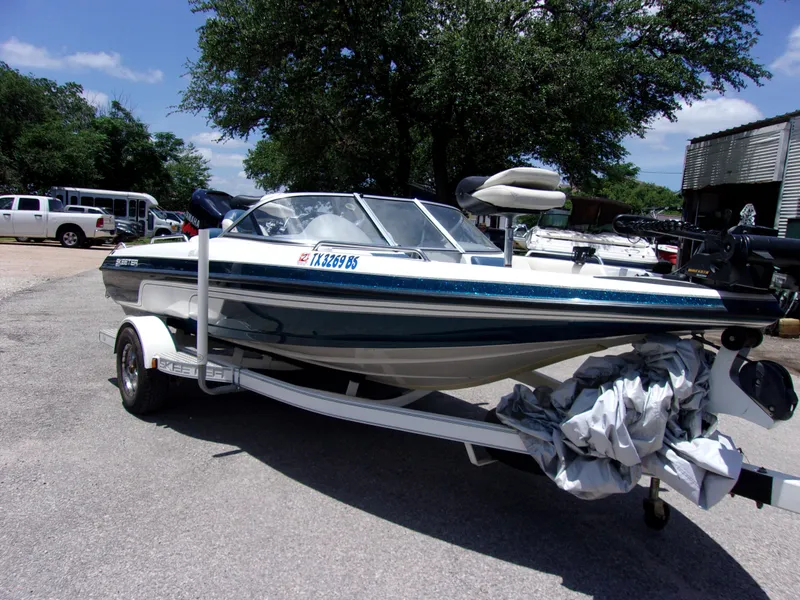 Slide: The Image of 2007 Skeeter SL 180 boat on a trailer in a parking lot. - 1