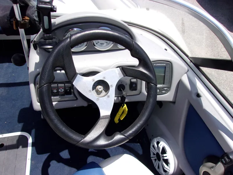 Slide: The Image of Steering wheel and dashboard of a 2007 Skeeter SL 180 boat. - 4