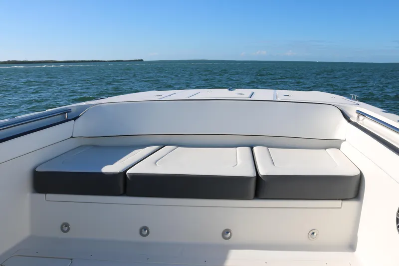 Slide: The Image of 2022 World Cat 400CC-X boat with cushioned seating on open water. - 6