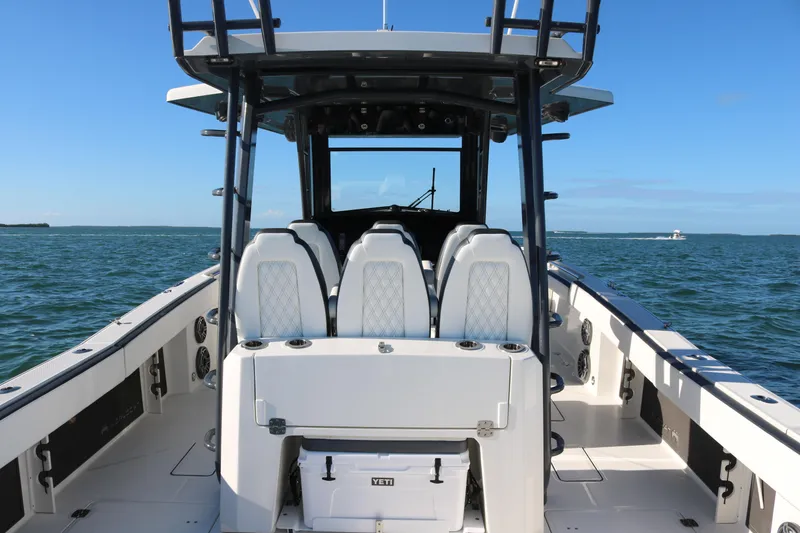 Slide: The Image of 2022 World Cat 400CC-X boat interior with seating and ocean backdrop. - 9