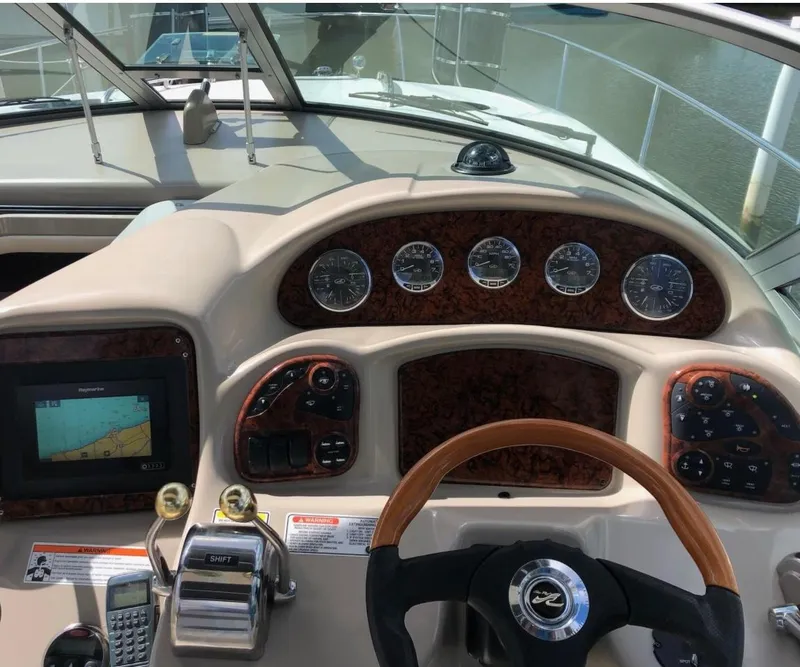 Slide: The Image of 2007 Sea Ray 320 Sundancer dashboard with navigation and control instruments. - 12