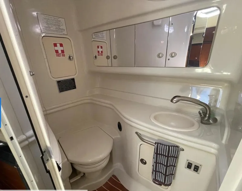 Slide: The Image of 2007 Sea Ray 320 Sundancer bathroom with sink, toilet, and storage cabinets. - 18