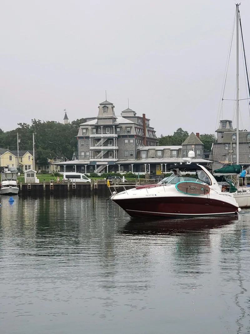 Slide: The Image of 2007 Sea Ray 320 Sundancer in a scenic harbor with historic buildings. - 3