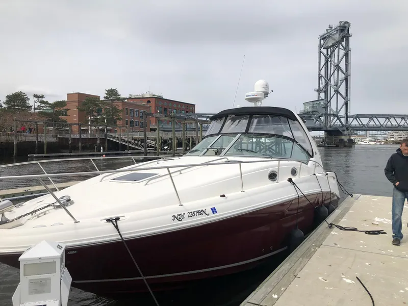 Slide: The Image of 2007 Sea Ray 320 Sundancer docked near a bridge on a cloudy day. - 5