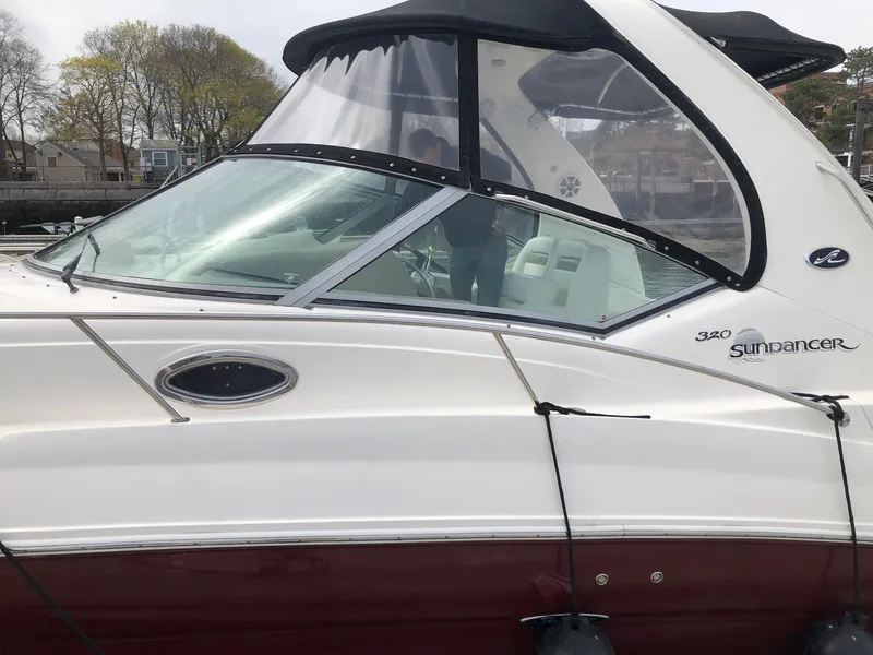 Slide: The Image of 2007 Sea Ray 320 Sundancer boat with sleek design and maroon hull. - 6
